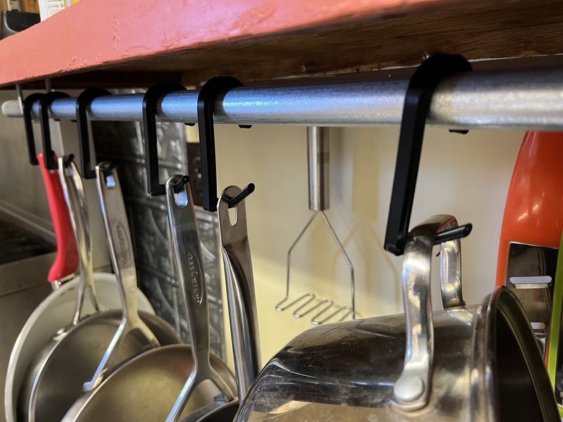 Pots hanging on our new pot rack with 3D printed hangers