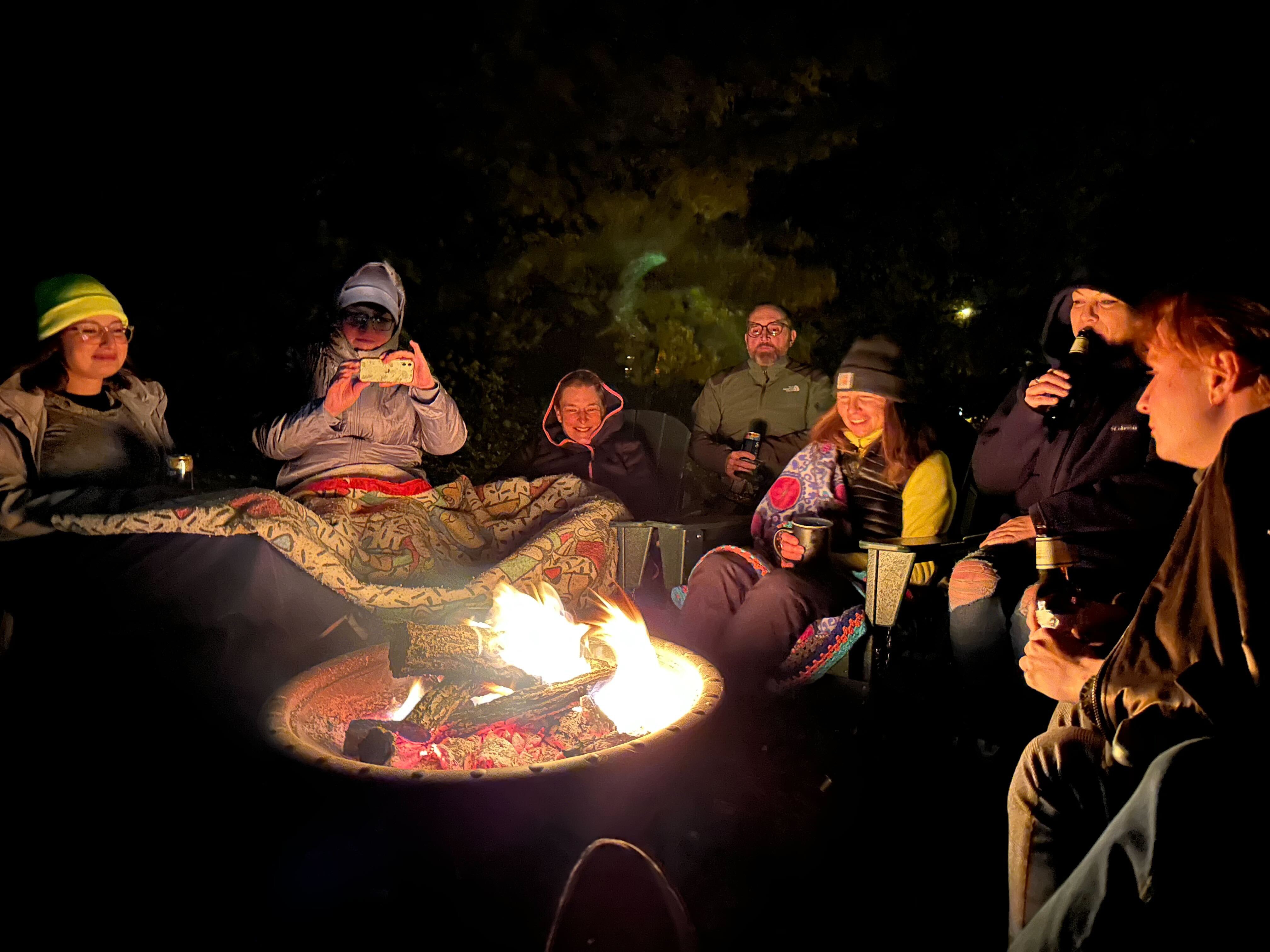 A retreat group laughing around the fire pit in FRC's back yard