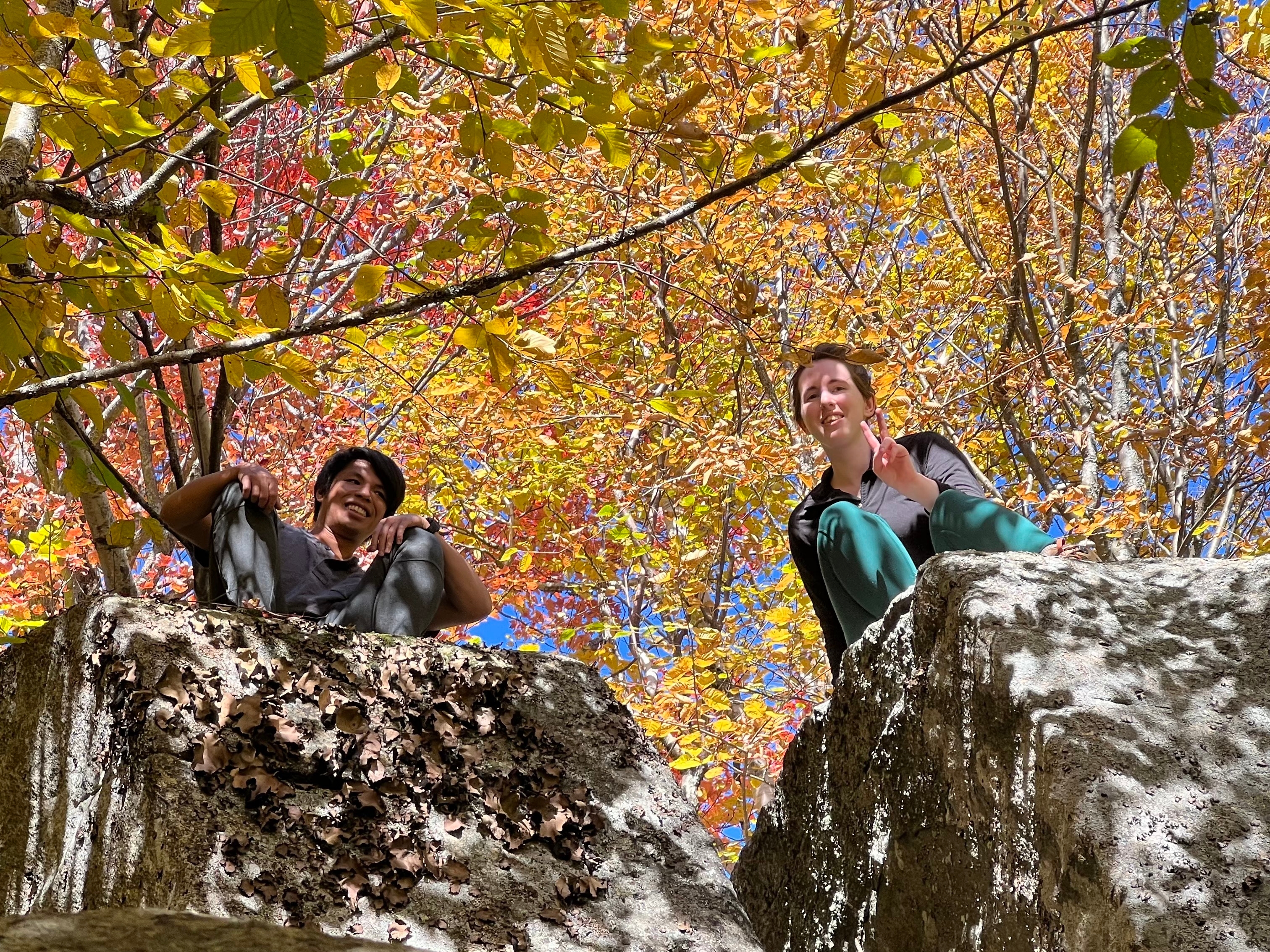 Climbing around some boulders on an autumn hike